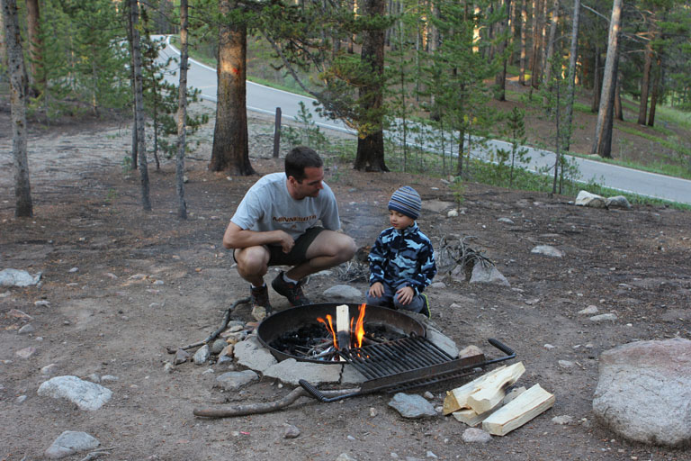 Daddy and Evan start the evening fire.