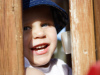 Alex playing peek-a-boo at the playground
