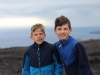 Alex and Evan bracing against the wind at Volcanoes National Park
