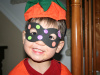 Evan shows off the mask he made at school