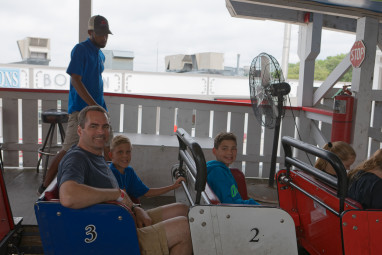 Dad and the boys board the coaster
